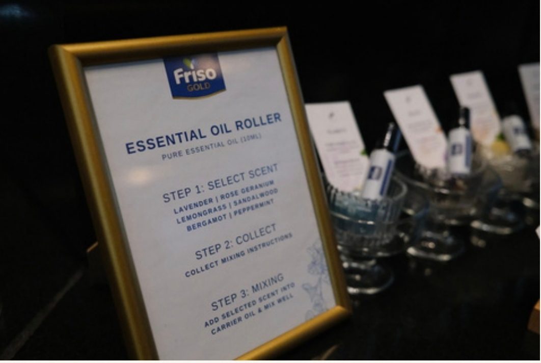 Essential oil roller station signage at a corporate event