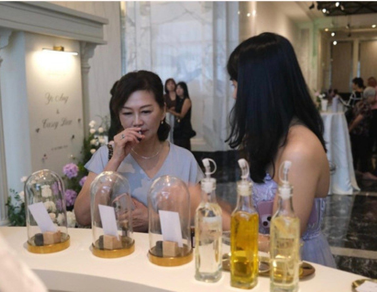Guest smelling an essential oil at the Samarata aroma booth